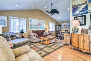 a living room with a couch and a table at 9 Mi to Ocean City Beaches Retreat with Patio in Berlin +21 photos