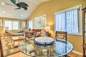 a living room with a glass table and chairs at 9 Mi to Ocean City Beaches Retreat with Patio in Berlin