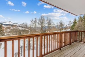 a balcony with a view of the snow covered mountains at Superb and calm flat with balcony in Megève - Welkeys in Megève