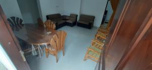 a living room with a wooden table and chairs at Family Time Holiday Home in Anuradhapura