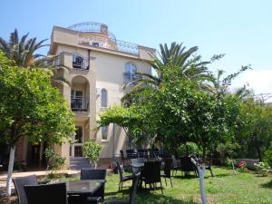 a building with tables and chairs in front of it at Villa Semashko in Bar