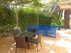 a patio with a table and chairs and a blue container at Villa Semashko in Bar +36 photos