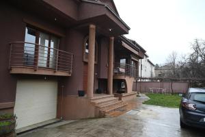 a house with a car parked in front of it at BOGO Apartment in Bitola