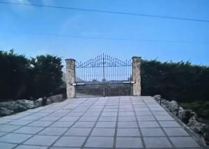 a gate at the end of a walkway at Sicilia tra cielo e mare con piscina in Palermo