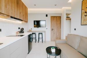 a kitchen and living room with a couch and a table at Aelia Prime Experience 2 in Kos