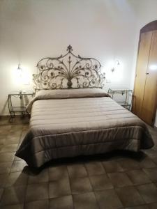 a bedroom with a large bed with a metal headboard at hotel de rossi in Bari