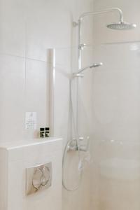 a white bathroom with a shower and a sink at Aelia Prime Experience 3 in Kos Town