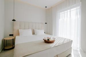 a bedroom with a bed with a basket on it at Aelia Prime Experience 3 in Kos Town