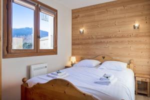 a bedroom with a bed with two towels on it at Cosy flat with terrace at the foot of the slopes in Megève - Welkeys in Megève