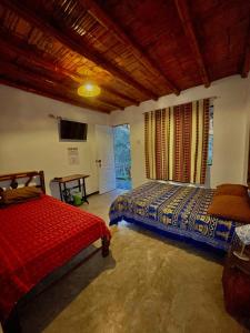 a bedroom with two beds and a flat screen tv at Rochabus in Ica