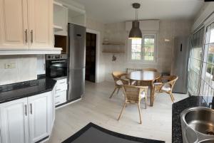 a kitchen with a table and a dining room at Ribadesella playa 3 in Ribadesella