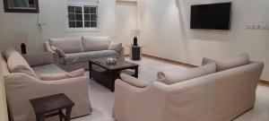 a living room with couches and a flat screen tv at شقه مفروشه للايجار اليومي in Makkah