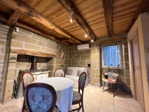 a kitchen with a table and chairs in a room at Le Pigeonnier de Lissac in Lissac-sur-Couze