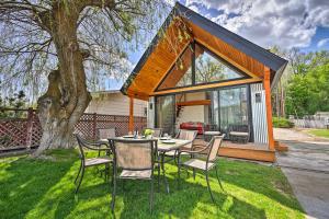 a house with a table and chairs in the yard at Beach Escape Scenic Osoyoos Lake Chalet! in Oroville