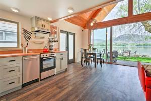 a kitchen and dining room with a view of the water at Beach Escape Scenic Osoyoos Lake Chalet! in Oroville