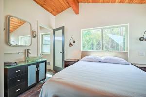 a bedroom with a large bed and a sink at Beach Escape Scenic Osoyoos Lake Chalet! in Oroville