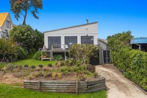 a house with a garden in front of it at Beach, Bikes and Bonfires in Opotiki