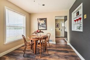 a dining room with a table and chairs at Waterfront Osoyoos Lake Cottage with Beach and Patio! in Oroville