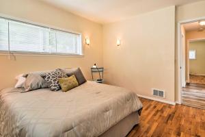 a bedroom with a bed and a window at Waterfront Osoyoos Lake Cottage with Beach and Patio! in Oroville