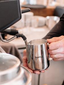 a person is holding a cup in a kitchen at De Zuileshoeve in Dordrecht