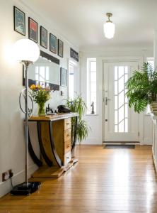 a living room with a table and a mirror at Twentieth Century B&B in Birchington