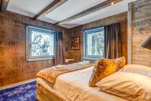 a bedroom with two beds and two windows at Luxury flat 2 steps to the cable cars in Megève - Welkeys in Megève