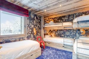 a room with two bunk beds and a window at Luxury flat 2 steps to the cable cars in Megève - Welkeys in Megève