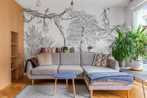 a living room with a couch and plants at City house with garden near Part-Dieu in Lyon - Welkeys in Lyon