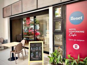 Reset (Hotel-Cafe-Coworking) في كالي: مطعم يوجد امامه طاولة و لافته