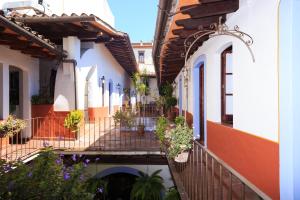 a row of houses with potted plants on the balconies at Meson del Alferez Xalapa in Xalapa