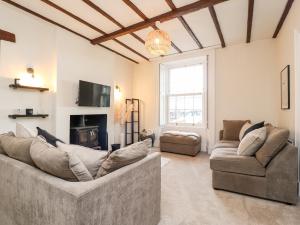 a living room with two couches and a fireplace at Hall Gowan in Carnforth
