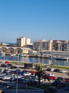 a parking lot with cars parked in a parking lot at Lovely apparment in fornt of the port of Gandia in Los Mártires