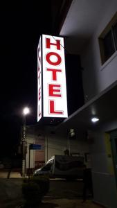 a neon sign for a hotel on the side of a building at Hotel Rota 282 in São Miguel dʼOeste