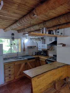 cocina con armarios de madera y encimera en Cabaña Los Abedules en Villa Pehuenia