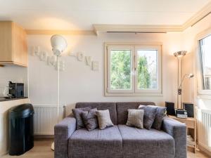 a living room with a couch and a window at Abija in Putten