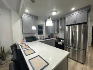 a kitchen with a refrigerator and a counter top at Modern Luxury Apartment near NYC in Jersey City