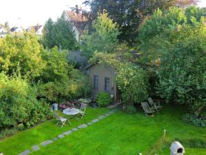 a garden with a table and chairs in the yard at 2 person holiday home in FALKENBERG in Falkenberg