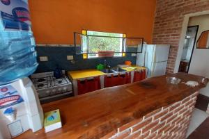 a kitchen with a counter top and a refrigerator at fatima cabaña 4personas in Villa de Las Rosas