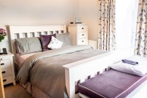 a bedroom with a large bed and a dresser at The Quay Pottery in Kent