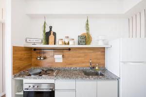 a kitchen with a sink and a white refrigerator at Top Rentals Downtown in Buenos Aires