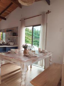 a wooden table in a kitchen with a large window at La Casa de Tita _ Usiacuri in Usiacurí