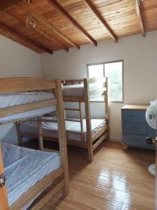 a room with two bunk beds and a window at La Casa de Tita _ Usiacuri in Usiacurí