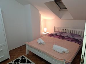 a bedroom with a bed with two towels on it at Wellcome to Sarajevo in Sarajevo