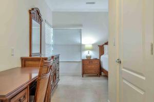 a bedroom with a desk and a bed and a mirror at Spacious 1BR APT Half Mile to Beach Pets Welcome in Lake Worth