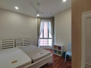 a bedroom with a large bed and a window at Ocean Palms in Melaka