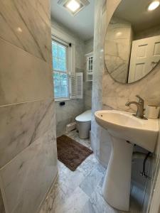 a bathroom with a sink and a mirror and a toilet at #17 ROOM IN THE HOUSE Peerless Design Room with Private Bathroom! in Waltham