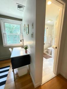 a home office with a desk and a bathroom at #17 ROOM IN THE HOUSE Peerless Design Room with Private Bathroom! in Waltham