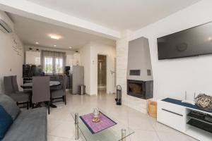 a living room with a couch and a fireplace at Villa Lana in Privlaka