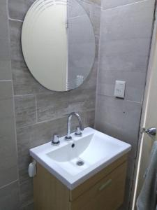 a bathroom with a sink and a mirror at Apartamentos Laguna de Navarro in Navarro