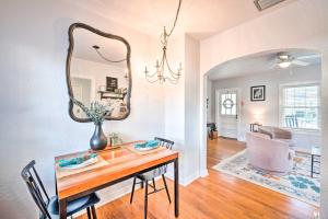 a dining room with a table and a mirror at about 12 Mi to Disney Downtown Winter Garden Cottage! in Orlando +18 photos
